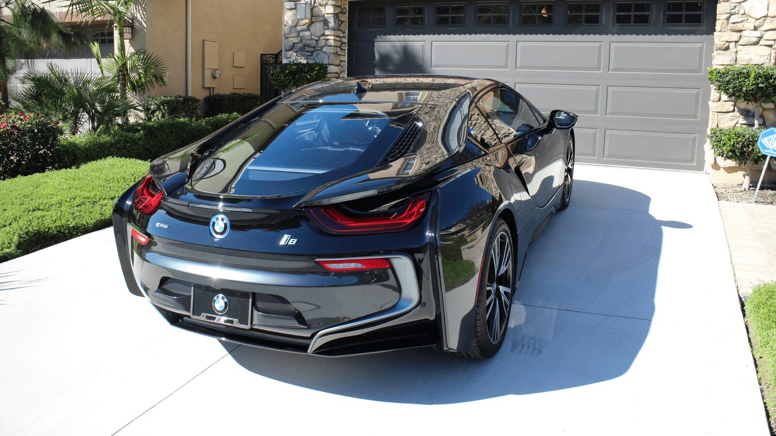 Black BMW i8 sports car freshly detailed in a driveway