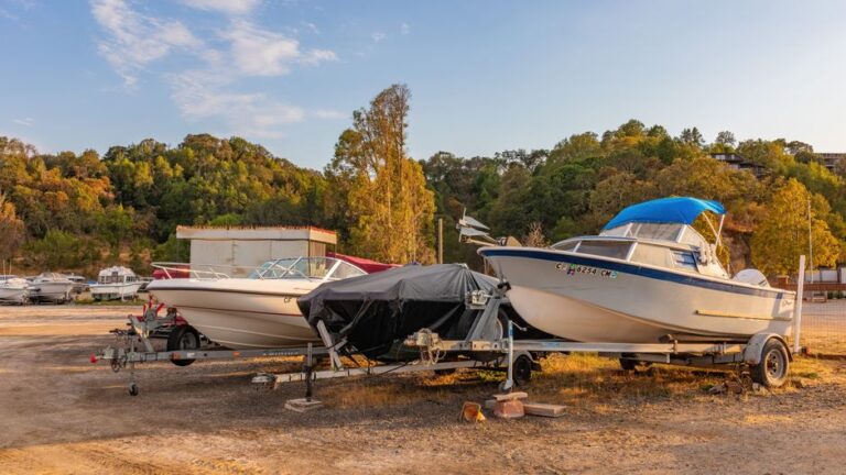 Real boats parked on trailers in a storage yard, ready for trailer-side detailing